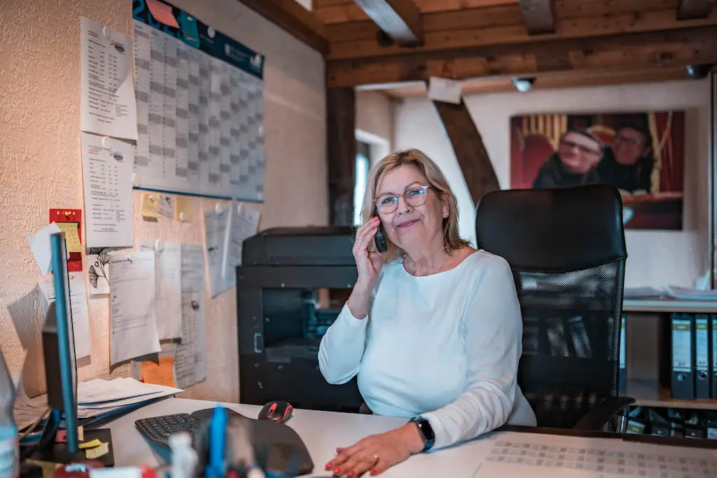 Freundliche Mitarbeiterin bei der Arbeit für Rohrreinigung Chorweiler, Kundenbetreuung im Büro.